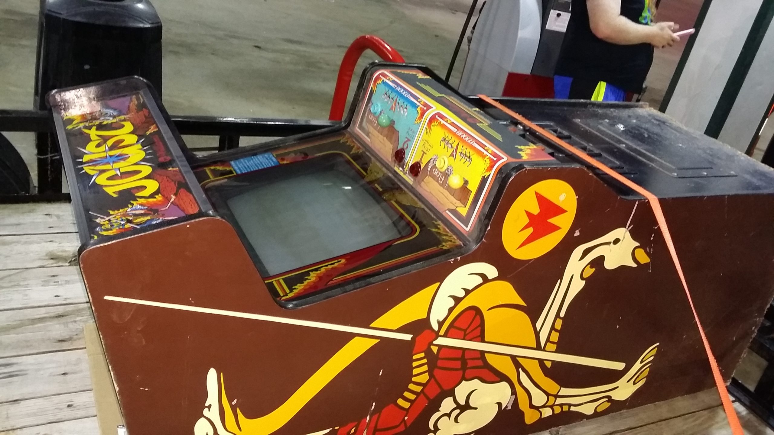 Joust cabinet strapped to a trailer bed