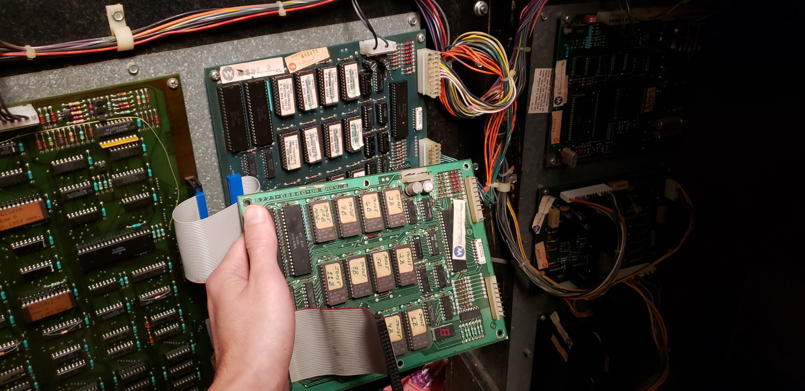 holding replacement ROM board in front of old ROM board