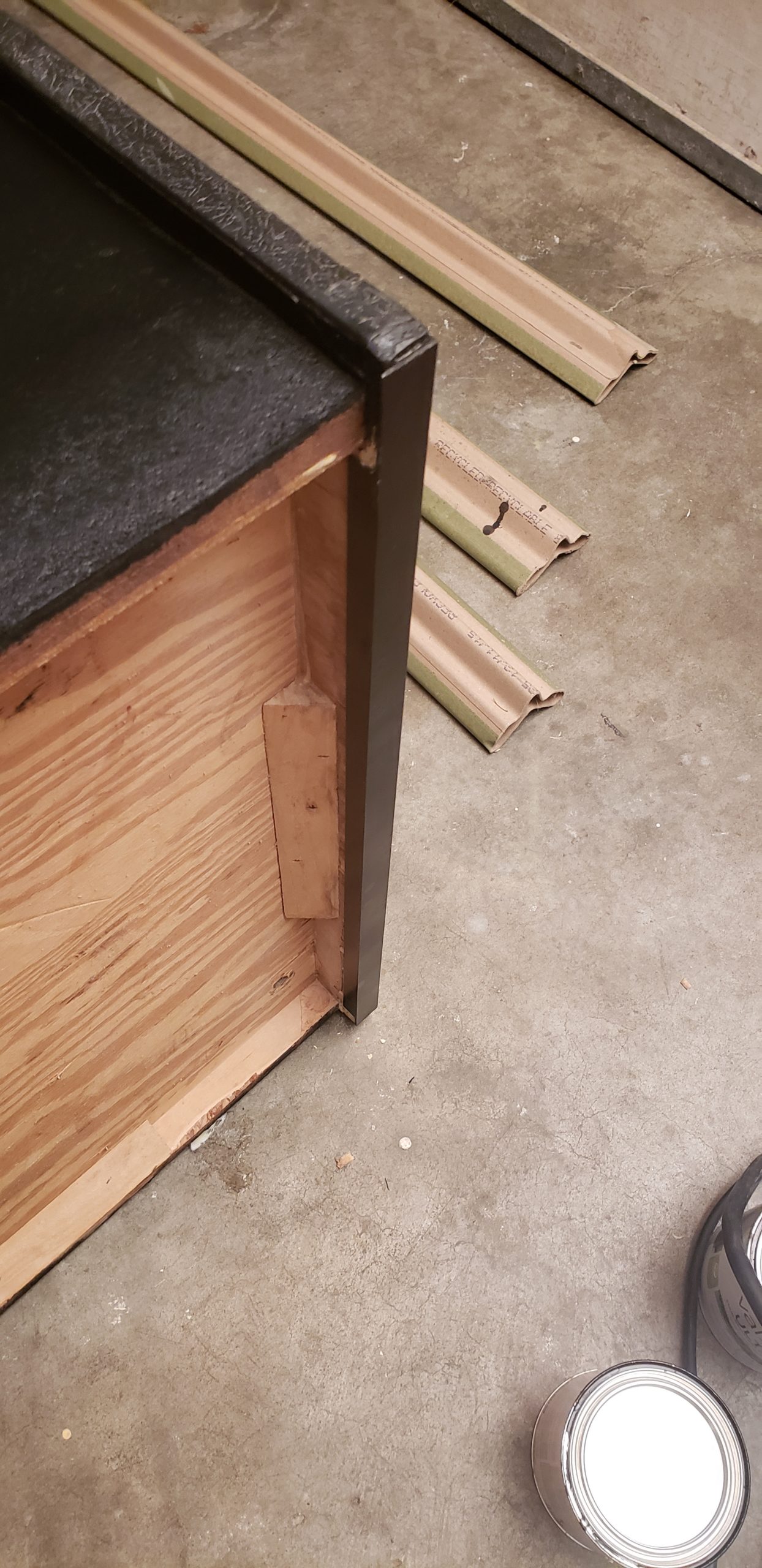 bottom of cabinet with metal channeling in place