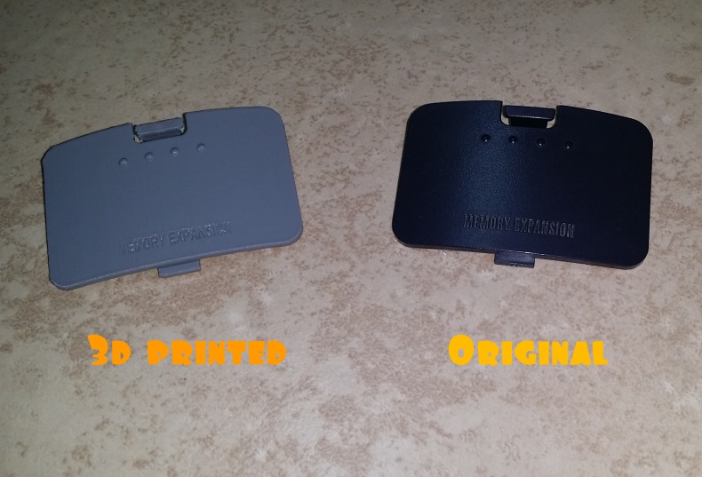 3D printed cover for N64 expansion slot next to an original one