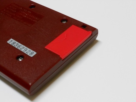 Game & Watch lying on its front so you can see the new battery cover